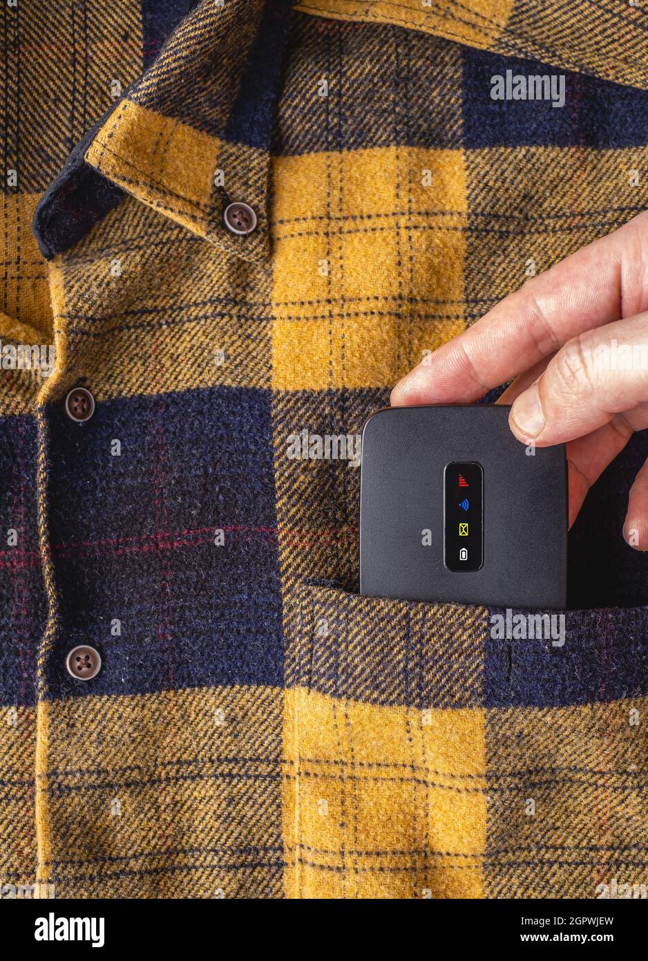 Mobile Pocket wifi router. Hand putting mobile wifi modem in shirt ...
