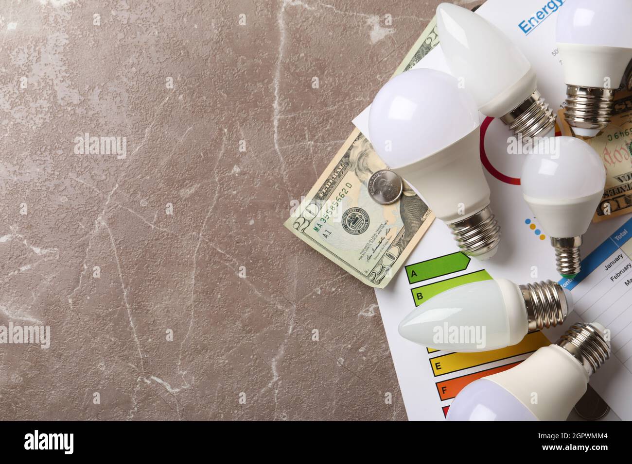 Energy saving concept on gray textured background. Stock Photo
