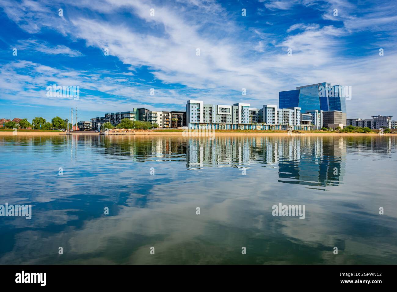 Reflection Of Buildings In Lake Against Sky Stock Photo