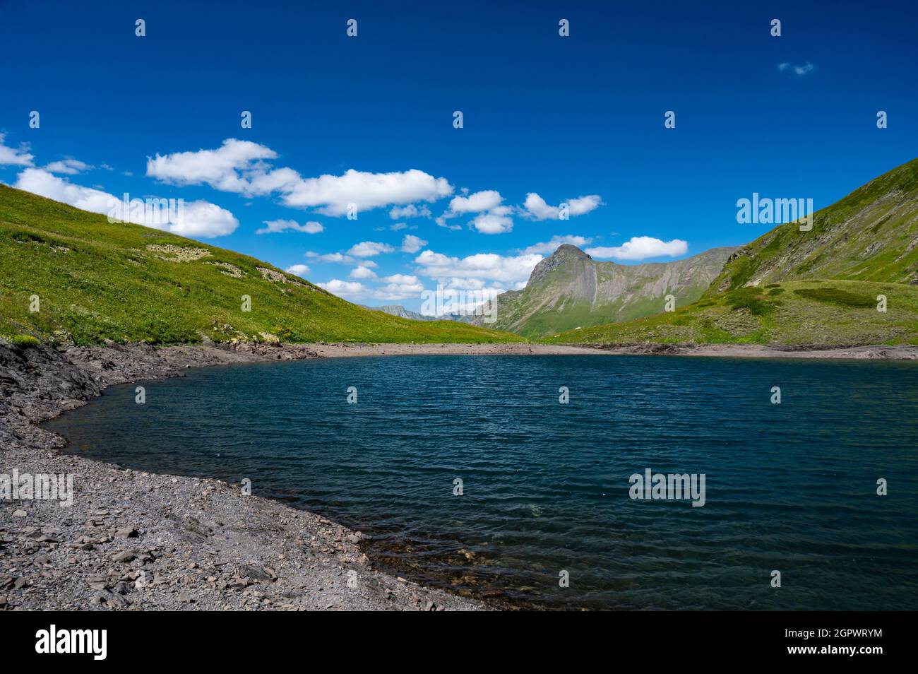Scenic View Of Lake And Mountains Against Blue Sky Stock Photo