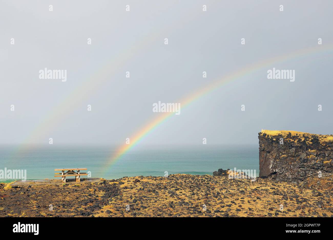 Scenic View Of Rainbow Over Sea Against Sky Stock Photo