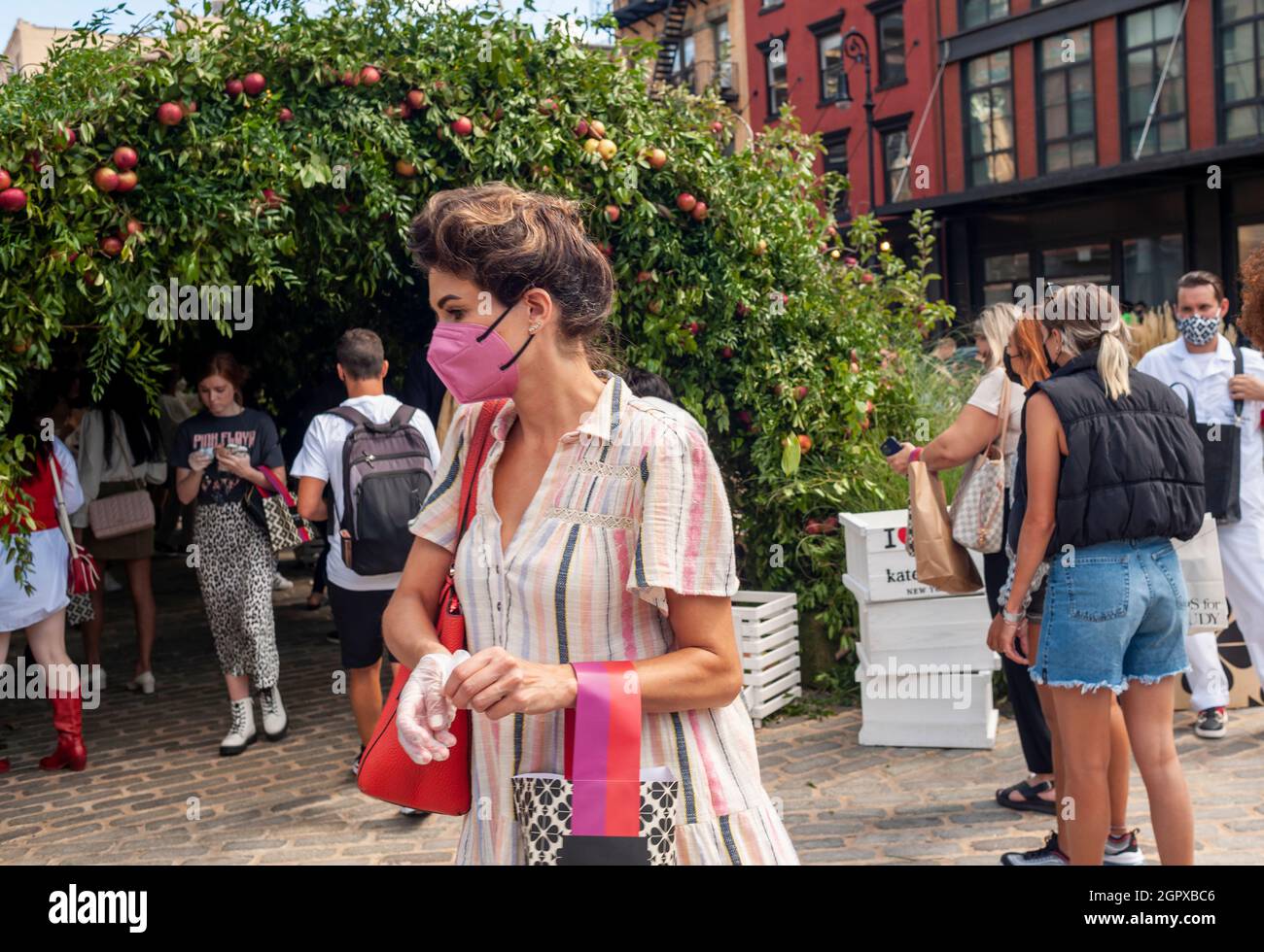 Fashionistas and the common public participate in the Kate Spade “Apple  Orchard” for New York Fashion Week in the Meatpacking District of New York  on Friday, September 10, 2021. Participants could pick