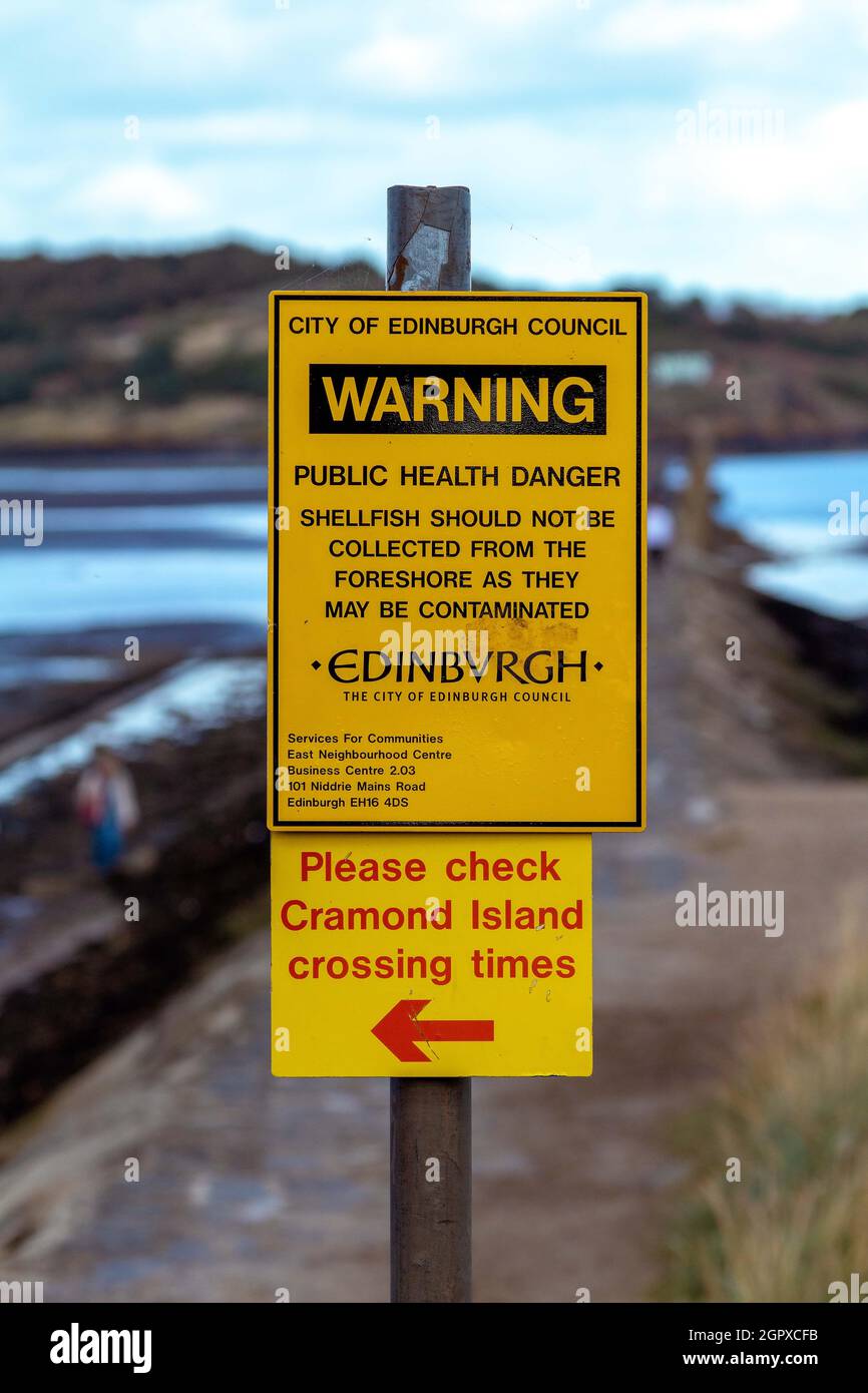 Warning sign before crossing to Cramond Island in north west Edinburgh