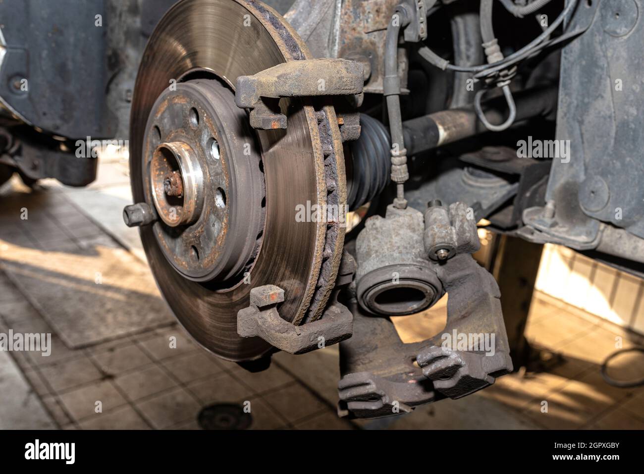 Disassembled Front Brake Caliper On The Car, Which Is On The Car Jack