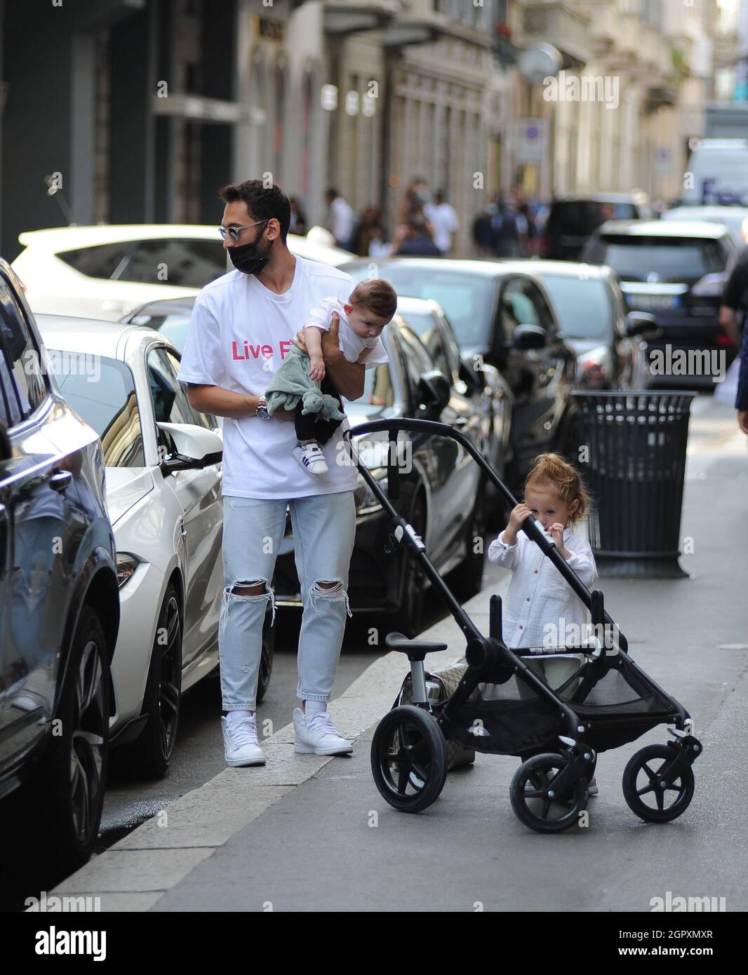 Milan, . 30th Sep, 2021. Milan, 30-9-2021 Hakan Calhanoglu, player of INTER  and of the national team of TURKEY, arrives in the center with his wife  Sinem Gundogdu and their children Liya