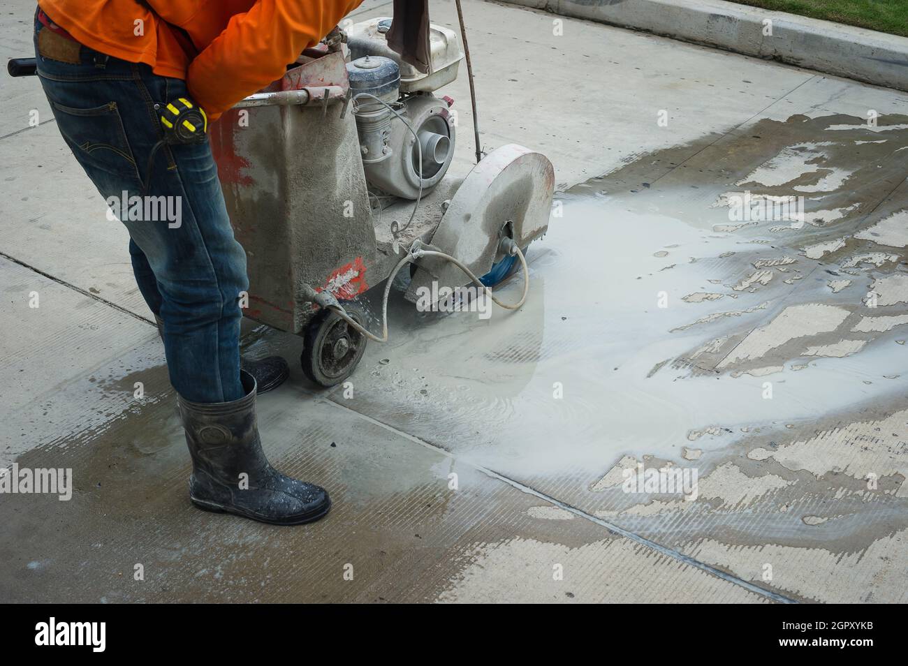 Road Worker Cutting Asphalt Road, Working On The Road Reconstruction