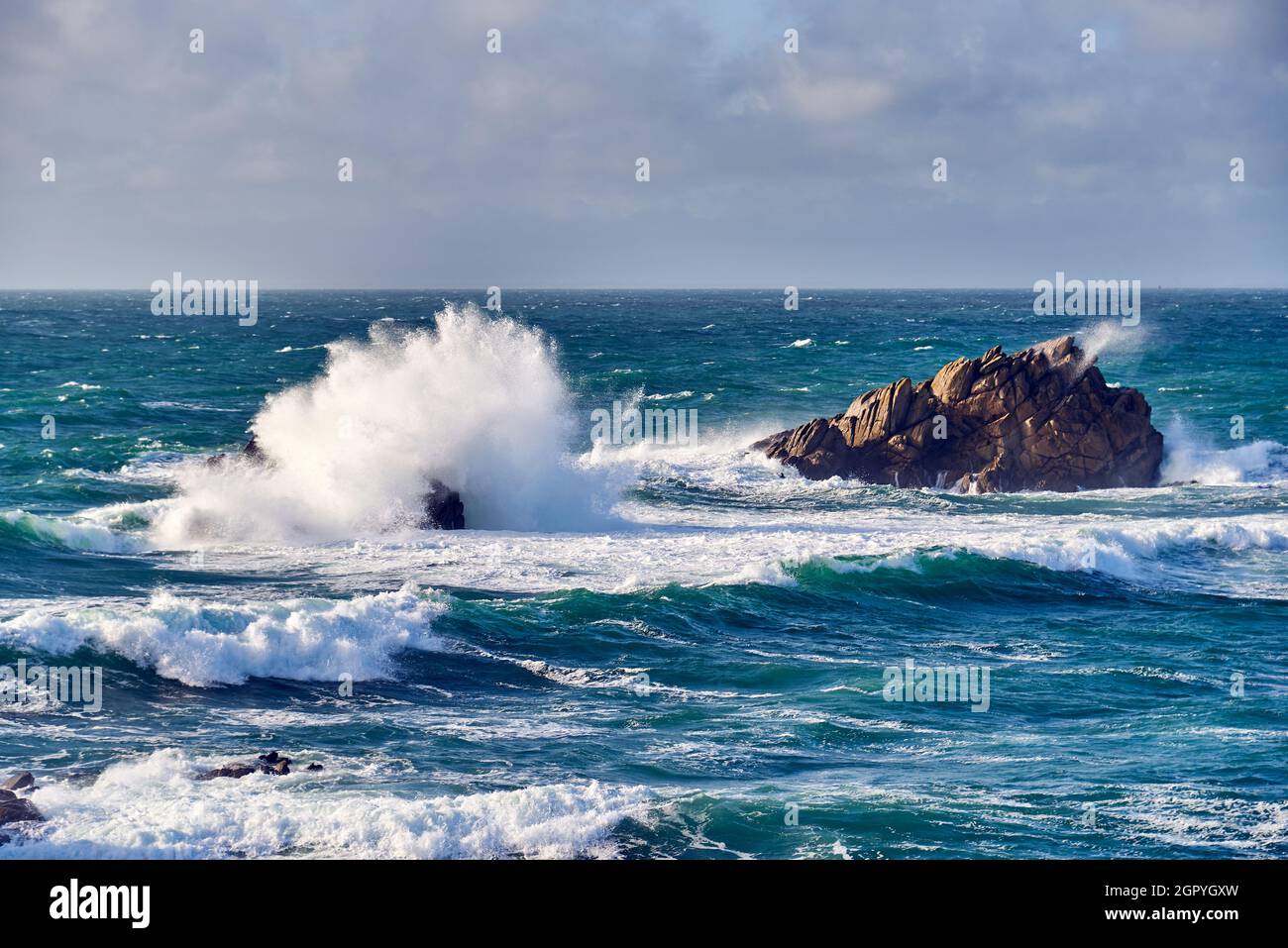 Waves Of The Atlantic Ocean Break On A Rock With Splashing Gout On Quiberon In Brittany In France Stock Photo