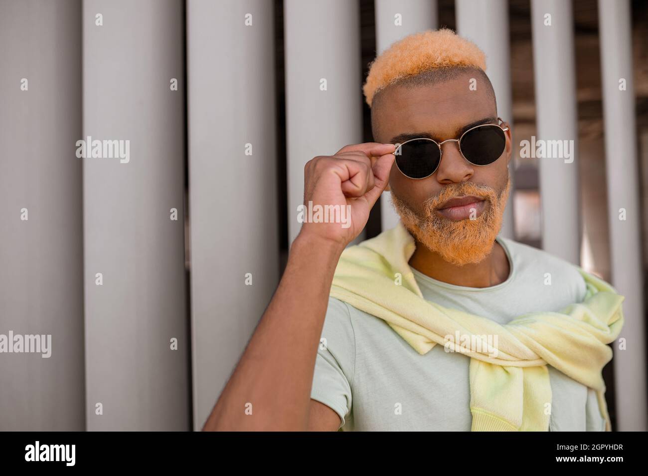 A bearded extravagant young man in sunglasses Stock Photo