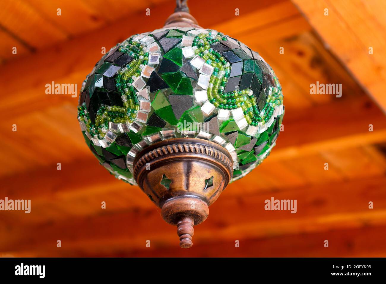 Arabic ceiling lamp with green crystals on wooden ceiling Stock Photo