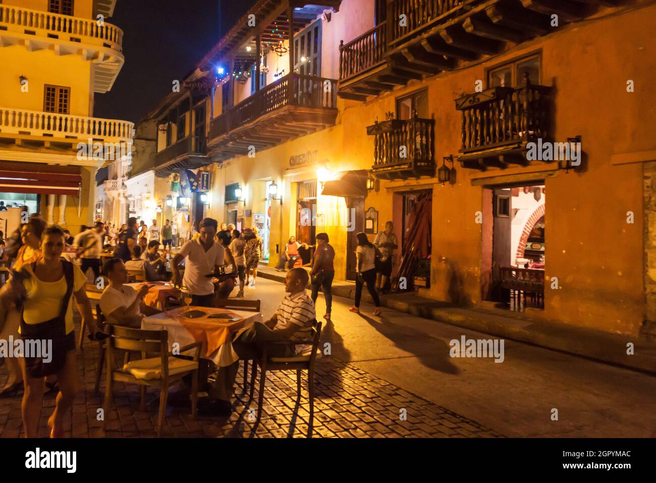 CARTAGENA DE INDIAS, COLOMBIA - AUG 27, 2015: People sit in cafes at Plaza Fernandez de Madrid square in Cartagena during the evening. Stock Photo