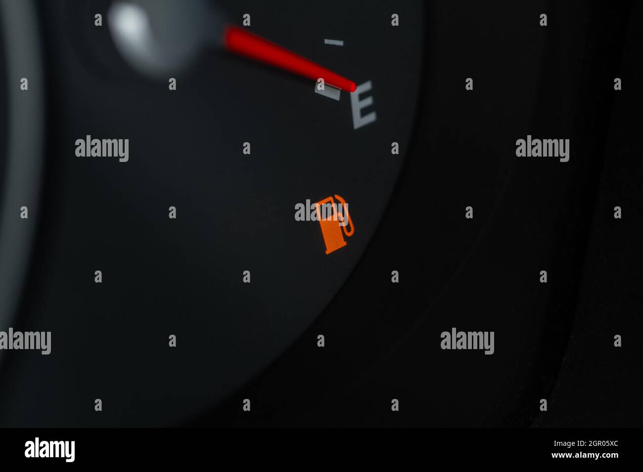 Empty fuel tank indicator close up view on modern car dashboard. Fuel