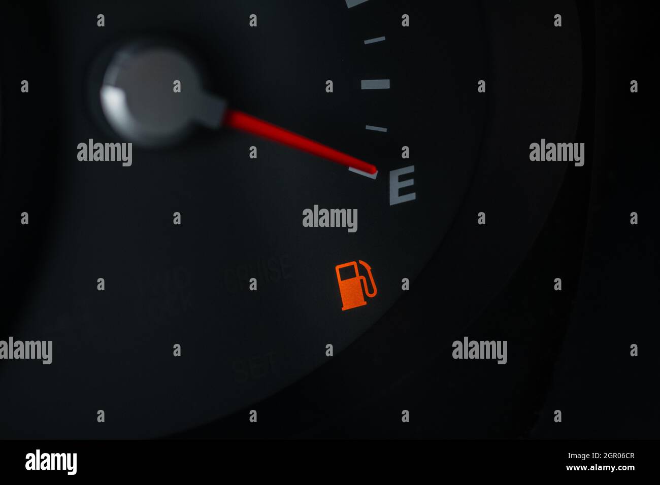 Close up view of the needle points to E indicating an empty fuel tank