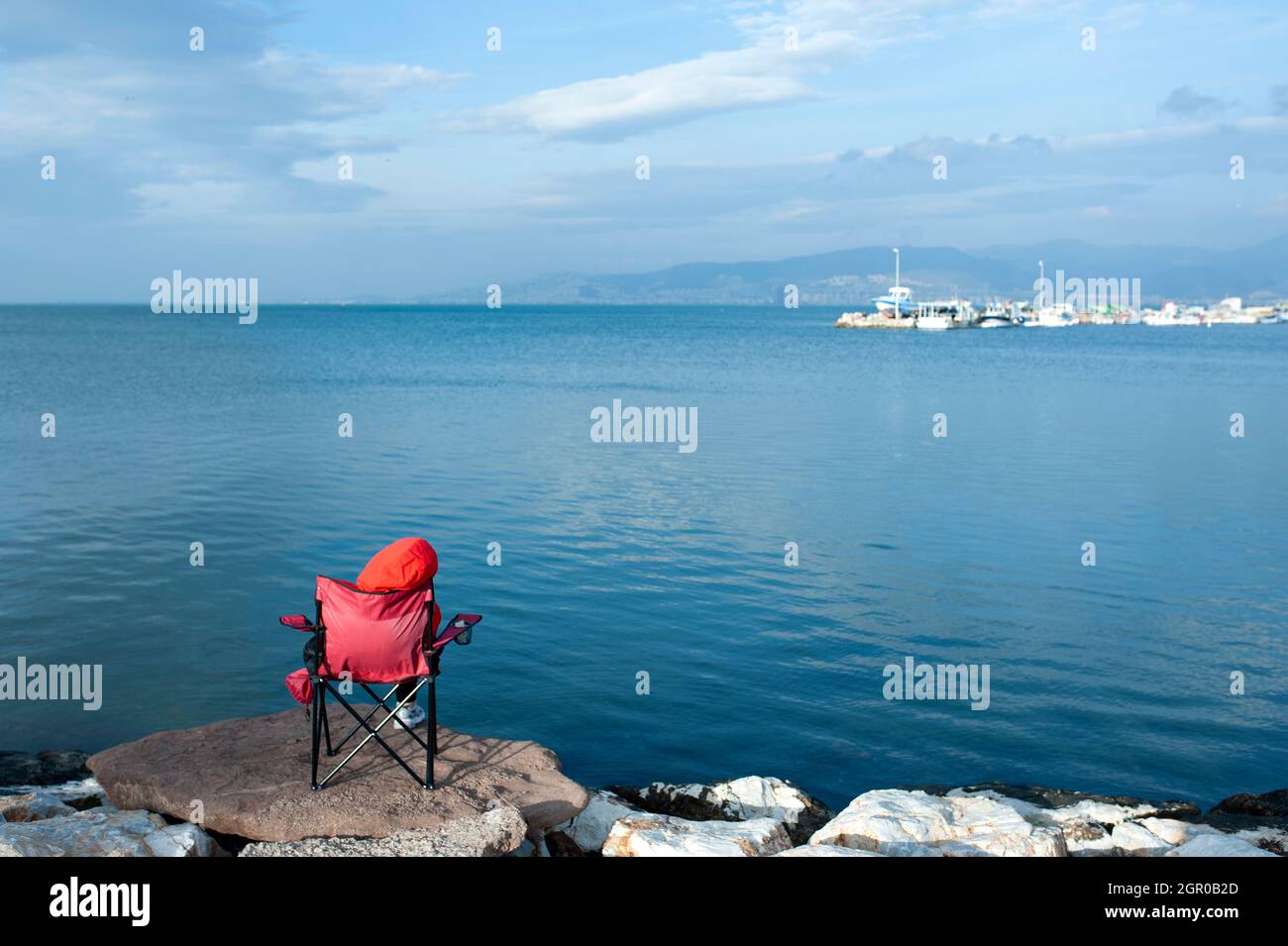 person sitting by the sea Stock Photo - Alamy