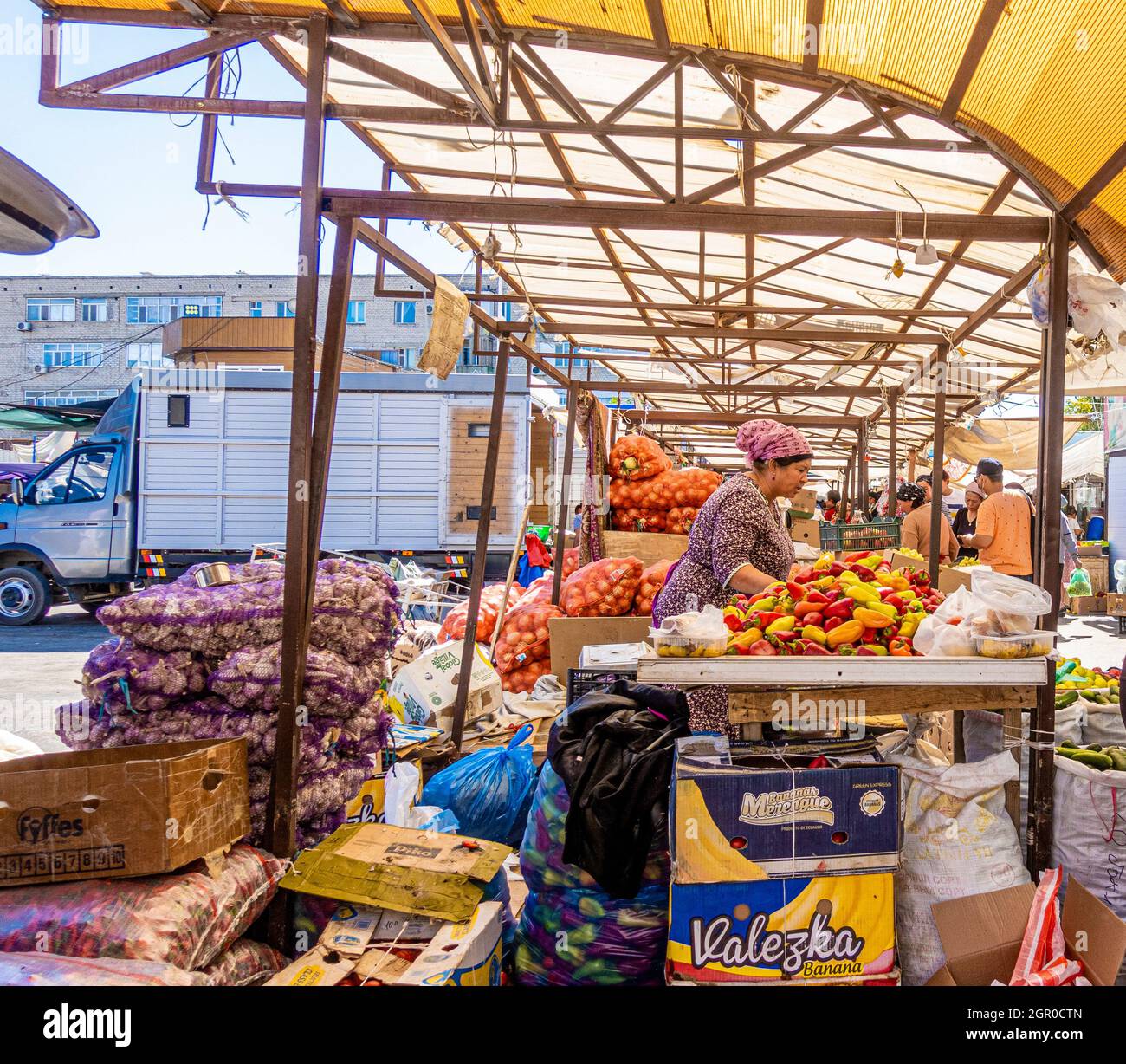 Woman selling vegetables at the stall on streetmarket bazar bazaar in Kyzyl-Orda, Kazakhstan, Central Asia Stock Photo