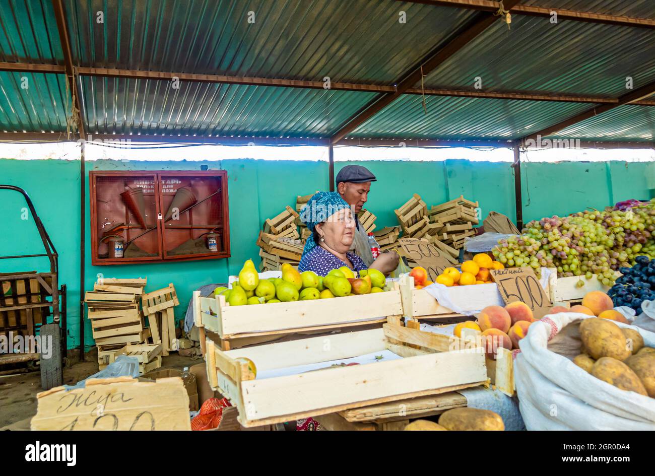 Woman selling pears at the fruit stall on streetmarket bazar bazaar in Kyzyl-Orda, Kazakhstan, Central Asia Stock Photo