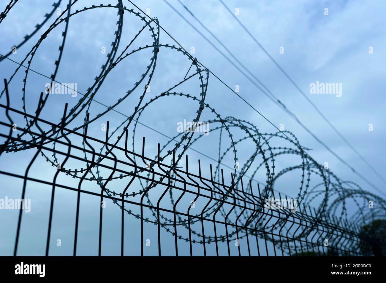 Barbed wire, wire mesh, iron fence Stock Photo