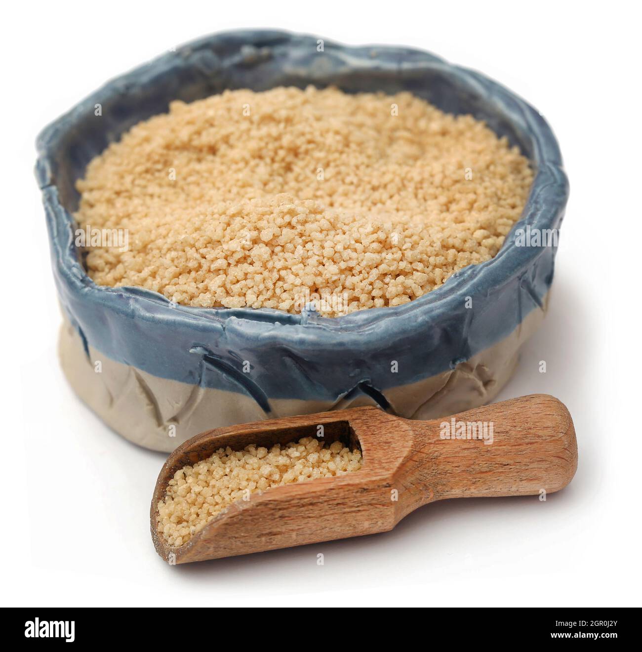 Uncooked couscous over white background Stock Photo Alamy