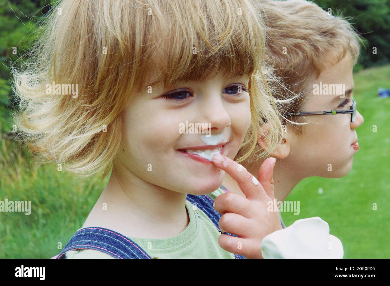 Portrait Of Cute Smiling Girl Holding Ice Cream Stock Photo