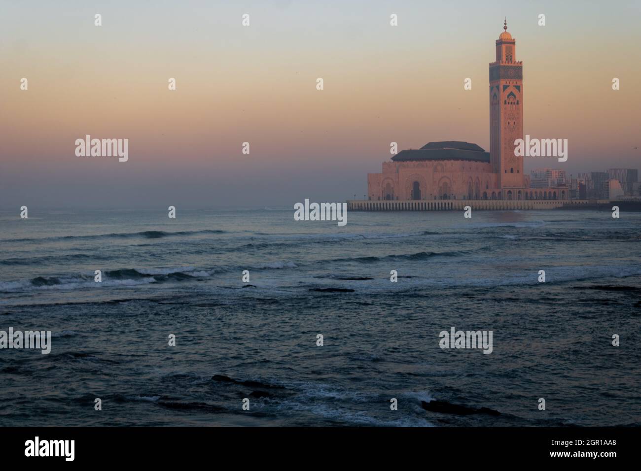 View Of Sea And Hassan 2 Mosque Against Sky During Sunset Stock Photo