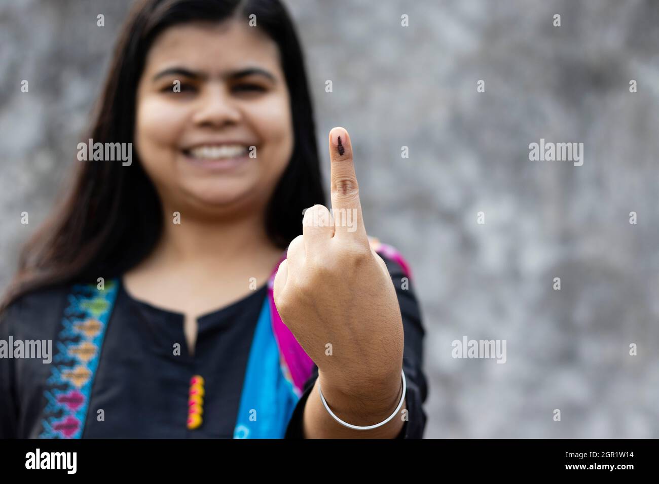 Selective Focus On Ink-marked Finger Of An Indian Woman With Smiling Face Stock Photo