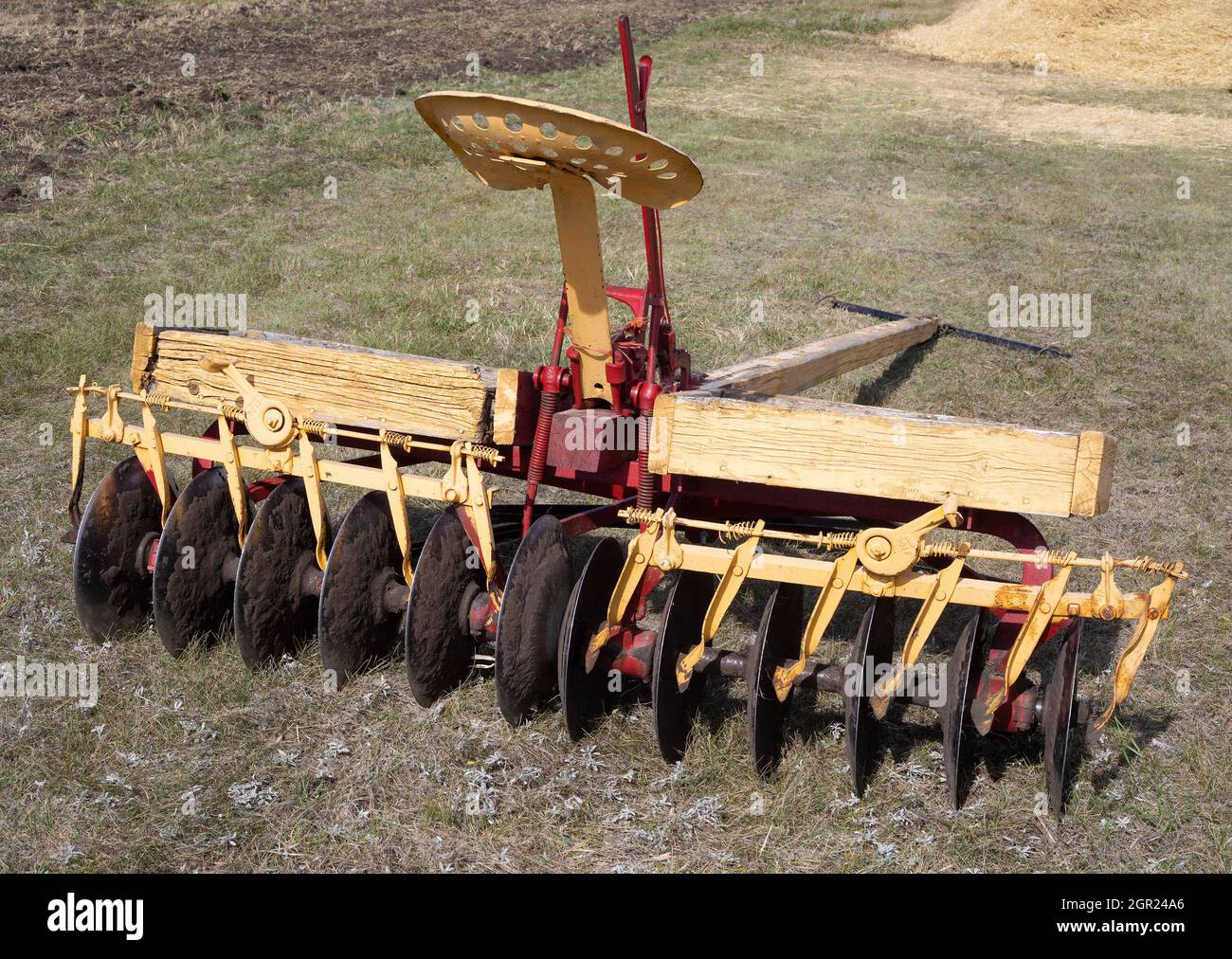 Old disc harrow or discer, an antique piece of farm equipment used to till soil in rural Alberta, Canada Stock Photo