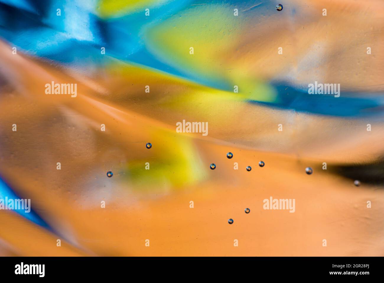 Water transparent abstract skew pastel orange-blue background with bubbles on glass. Stock Photo
