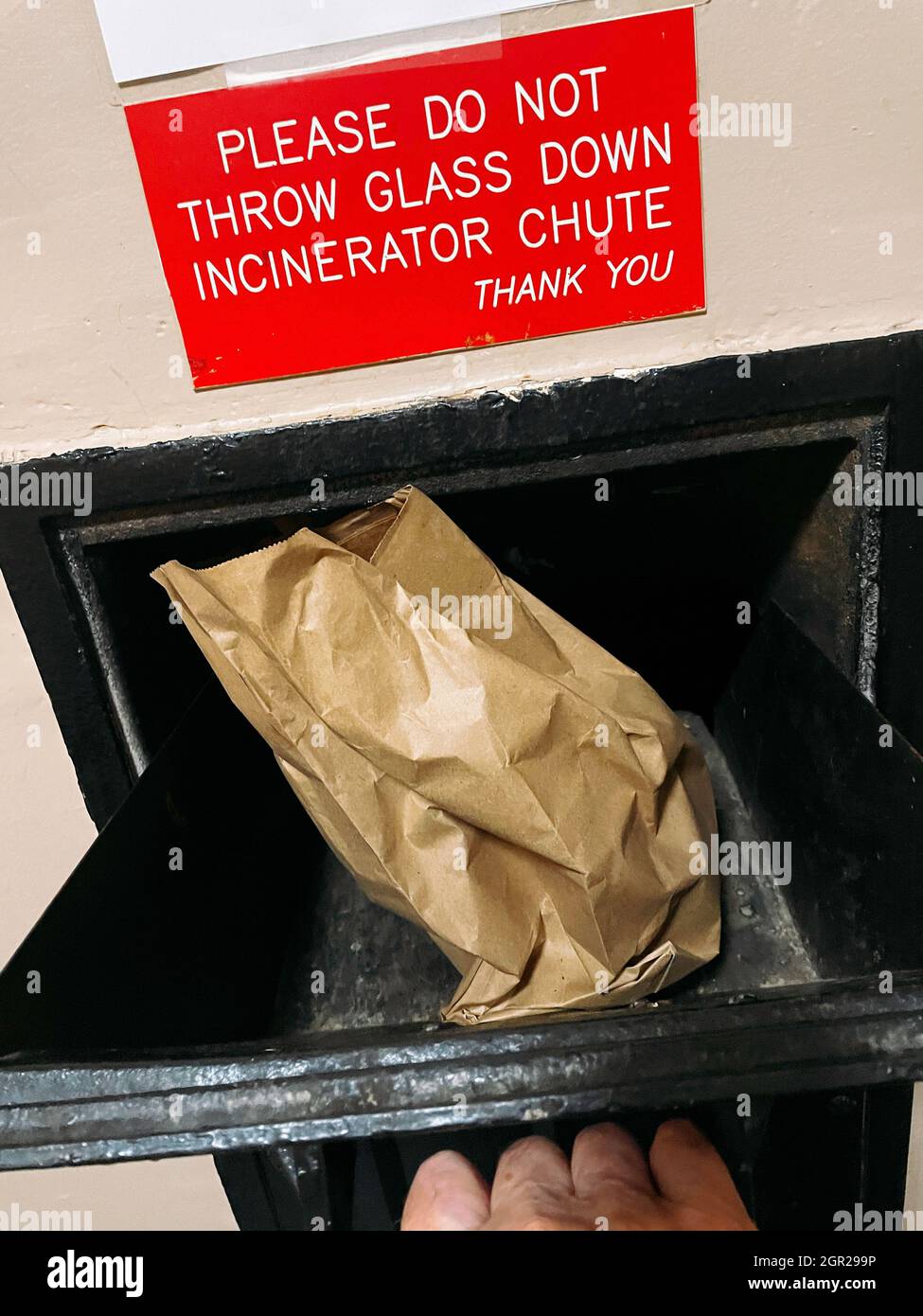 https://c8.alamy.com/comp/2GR299P/bagged-trash-in-an-apartment-building-garbage-chute-opening-2021-nyc-usa-2GR299P.jpg