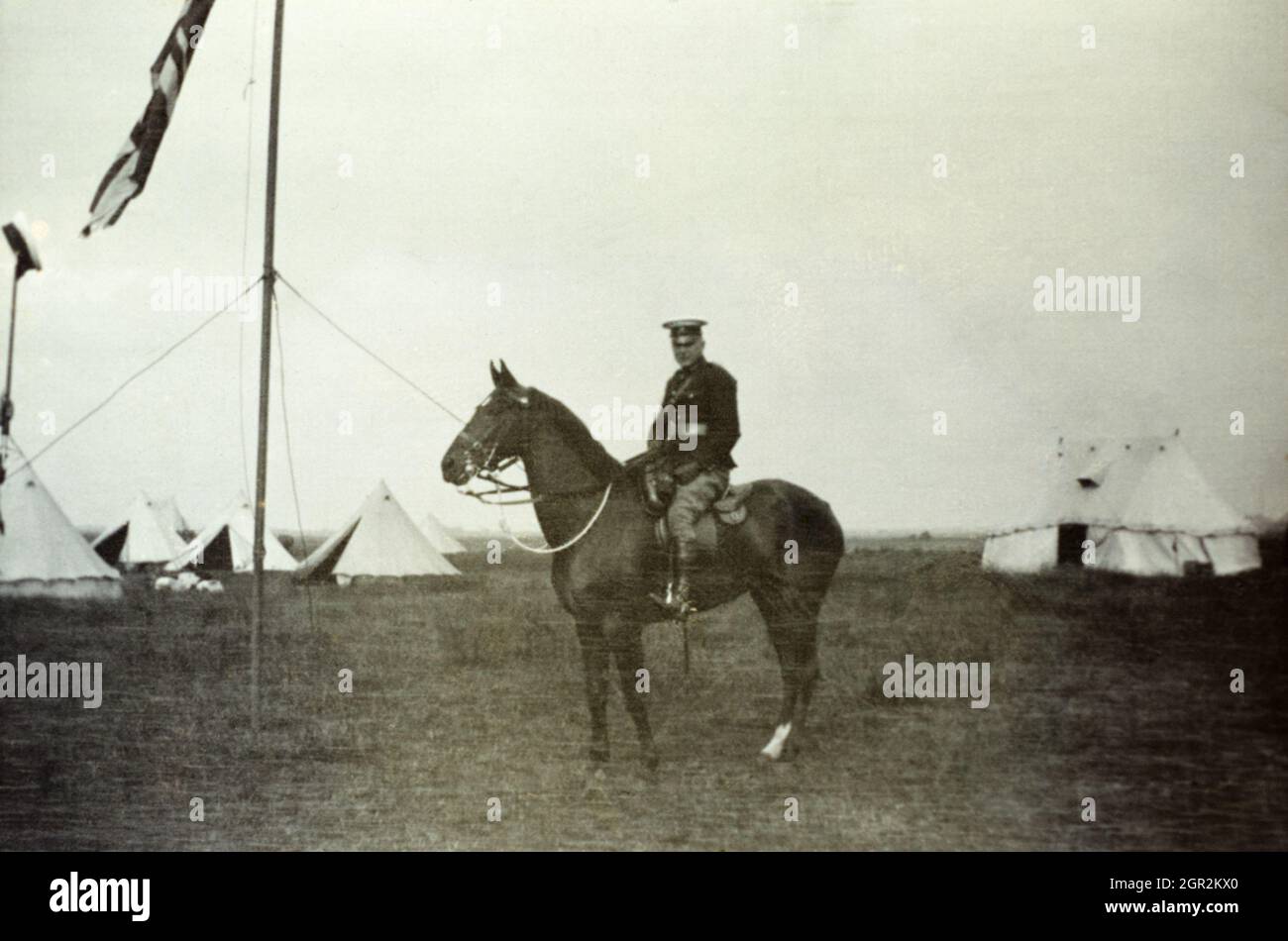 An Edwardian era British army officer mounted on a horse in camp. Stock Photo