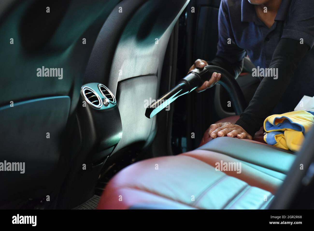 Worker Cleaning Of Interior Back Seat 