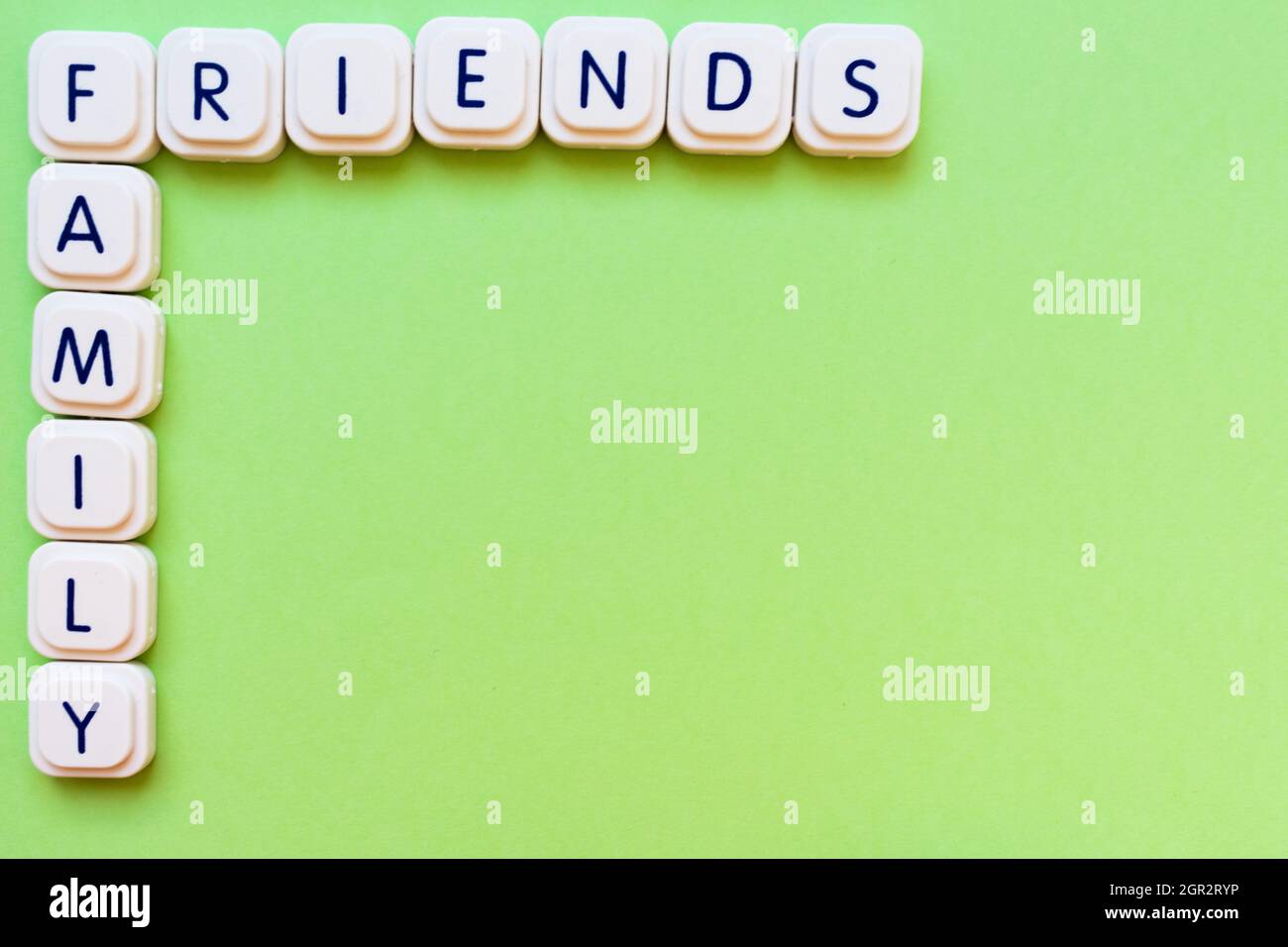 Family And Friends Words Made With Board Game Letters, On The Top Corner,  Over A Green Background Stock Photo - Alamy