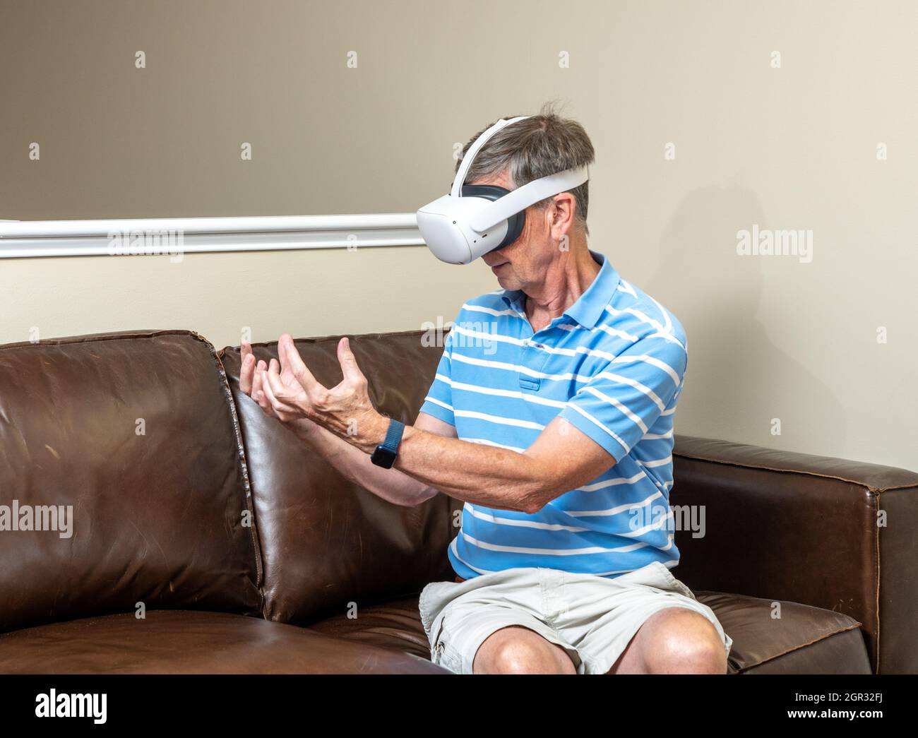Senior man reaching for object on a modern virtual reality VR headset