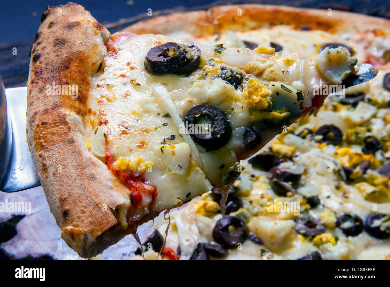 Portuguese Pizza, onion, peppers, pepperoni, egg, olive Stock Photo Alamy