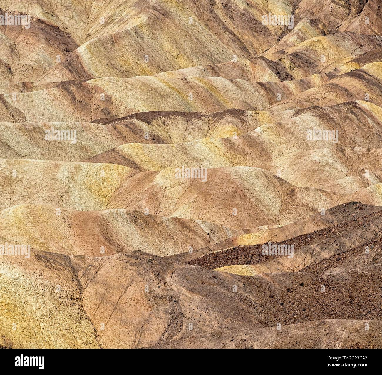 Colorful badlands composed of an ancient lakebed in the area surrounding Zabriskie Point in Death Valley Stock Photo