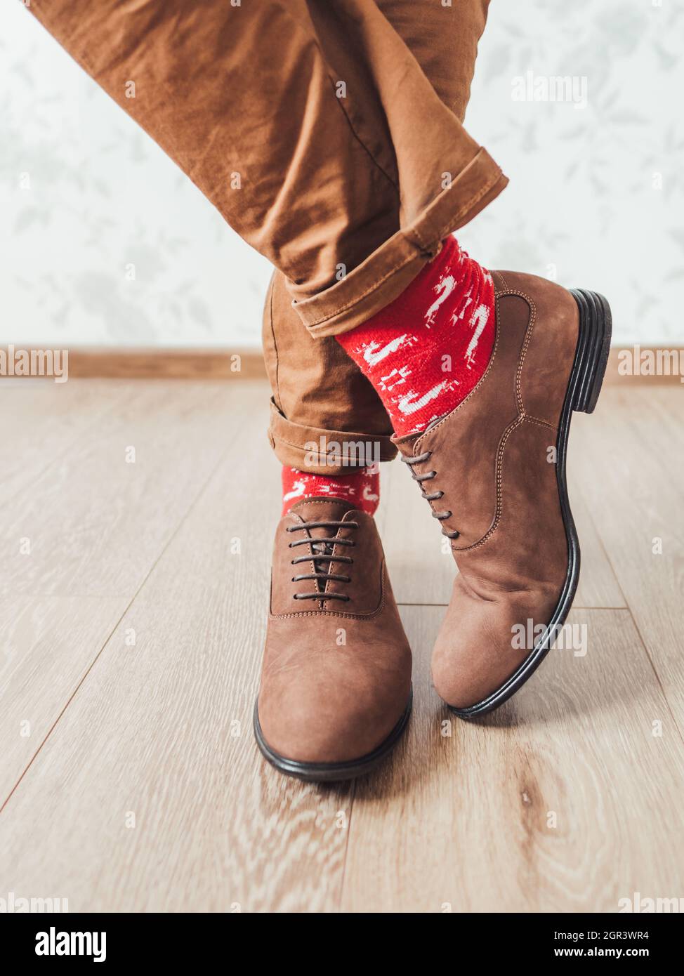 Young Man In Chinos Trousers, Red Socks With Reindeers. Scandinavian  Pattern. Winter Casual Outfit Stock Photo - Alamy