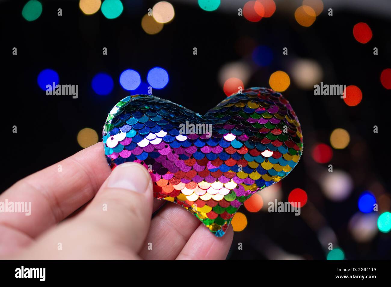 Close-up Of Hand Holding Heart Shape Decoration Against Blurred Background Stock Photo
