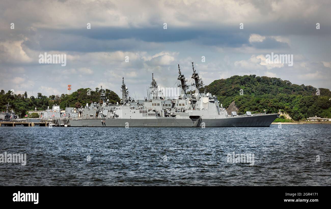 The Japan Maritime Self-Defense Force (JMSDF) docks with ships sitting in the harbor at Yokosuka, Japan. Stock Photo