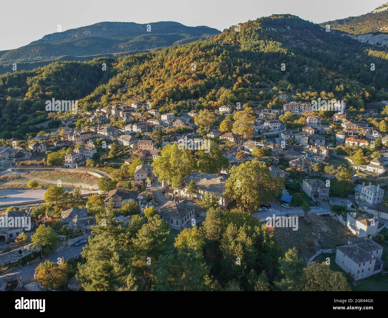 Aerial panoramic view over the picturesque village Papigo in Epirus, Greece at sunset. Scenic aerial view of traditional Greek villages in Autumn. Epi Stock Photo
