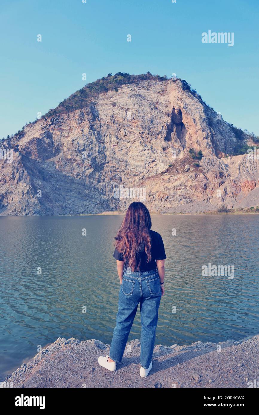 Full Length Of Woman On Rock Against Sky, Lanmark, Long Hair, Swamp, Stock Photo