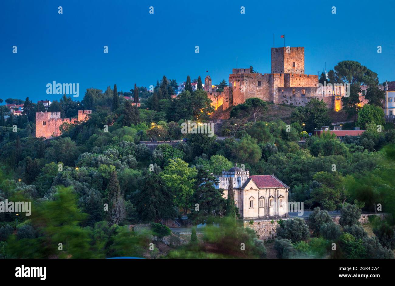 Beautiful landscape of Tomar Castle at dusk, with the Chapel of Nossa Senhora da Conceição at the bottom, in the city of Tomar, Portugal. Stock Photo