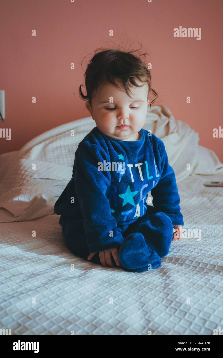 Cute Girl Sitting On Bed At Home Stock Photo Alamy