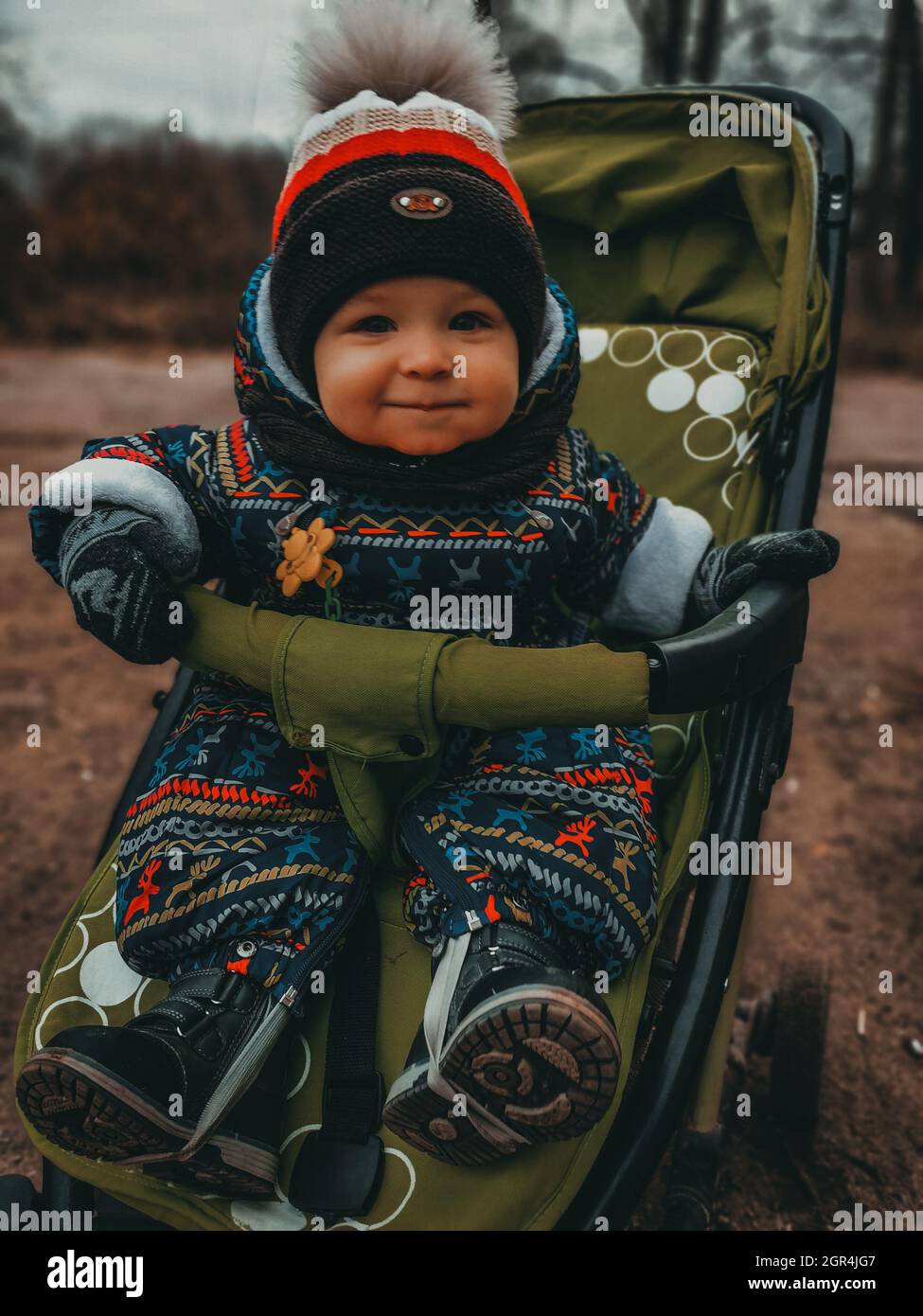 Portrait Of Cute Boy In Stroller In Winter Stock Photo