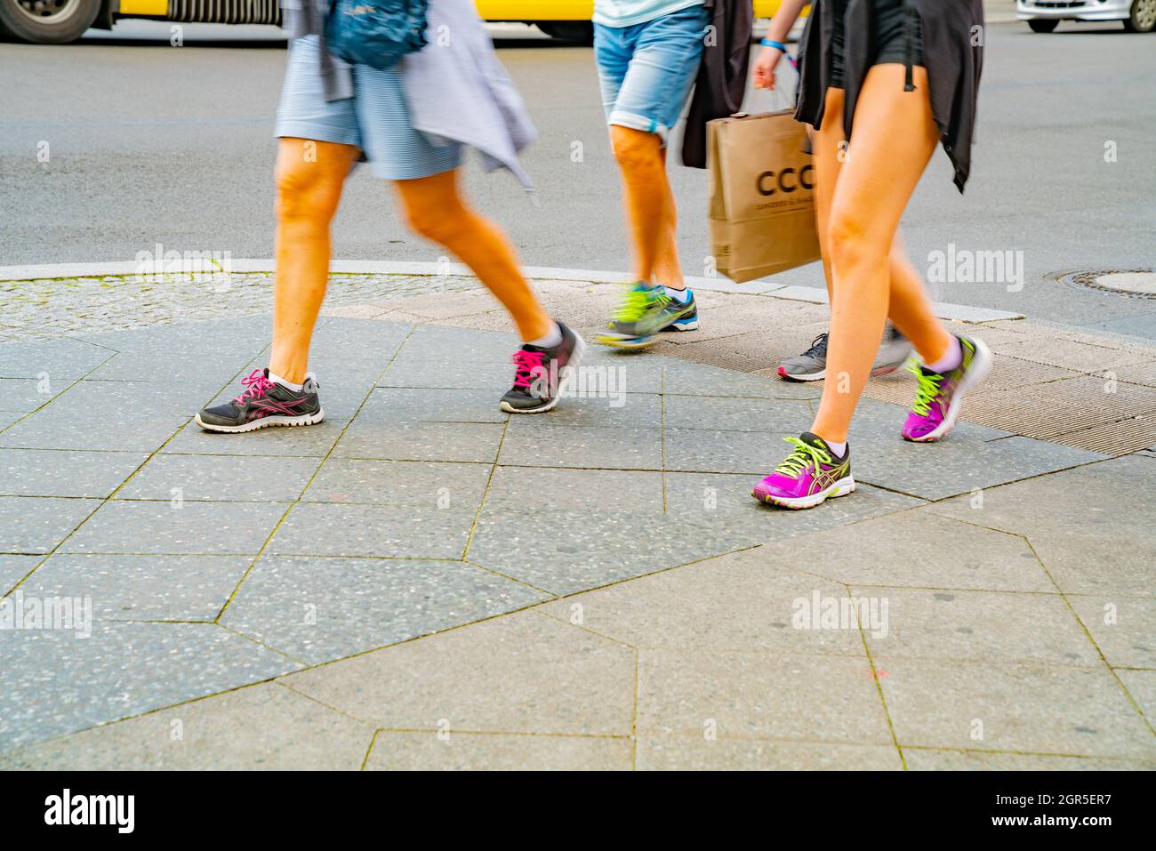 Berlin, Germany - September 25, 2017: Four girls in sports shoes blurred  while walking on pavement one carring shopping bag Stock Photo - Alamy