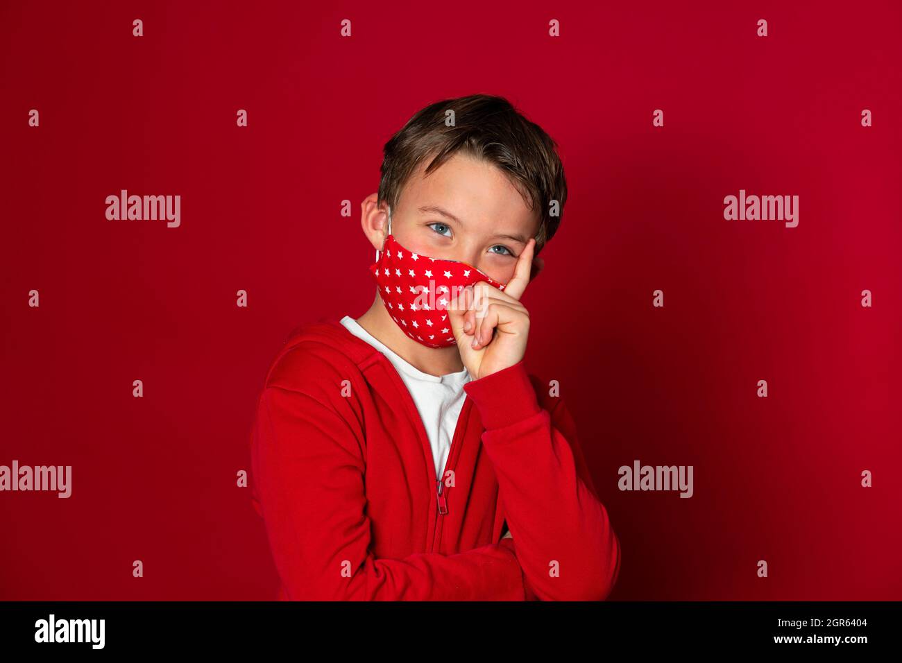 Cute Boy Wearing Mask Against Red Background Stock Photo Alamy