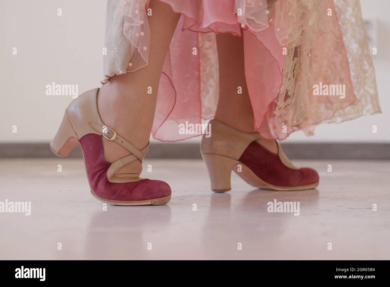 Pink And Beige Shoes For Flamenco Dance On Women's Legs. Close-up. Stock Photo