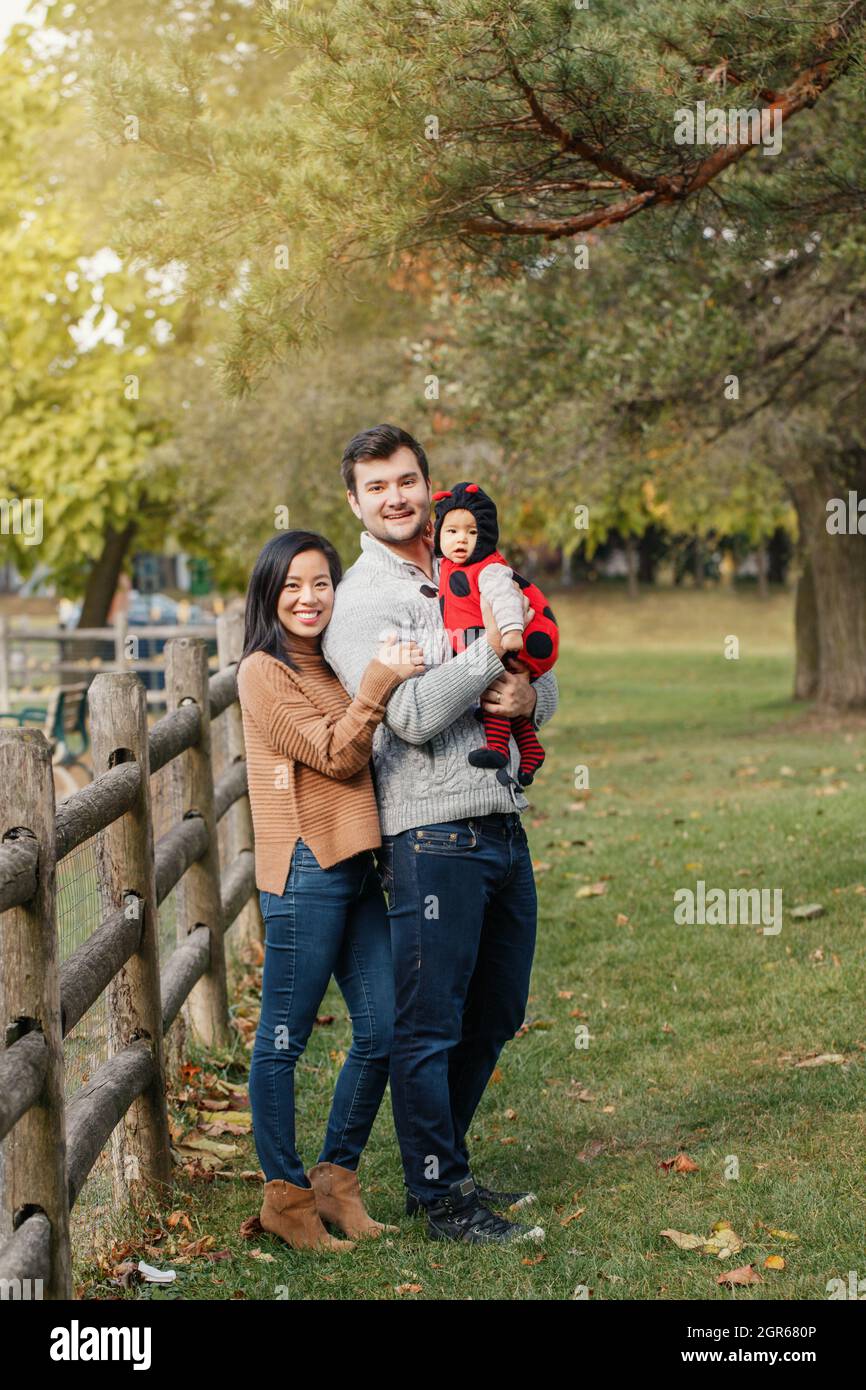 Happy Halloween. Chinese Mother And Caucasian Father Dad With Baby Girl In  Ladybug Halloween Costume Stock Photo - Alamy