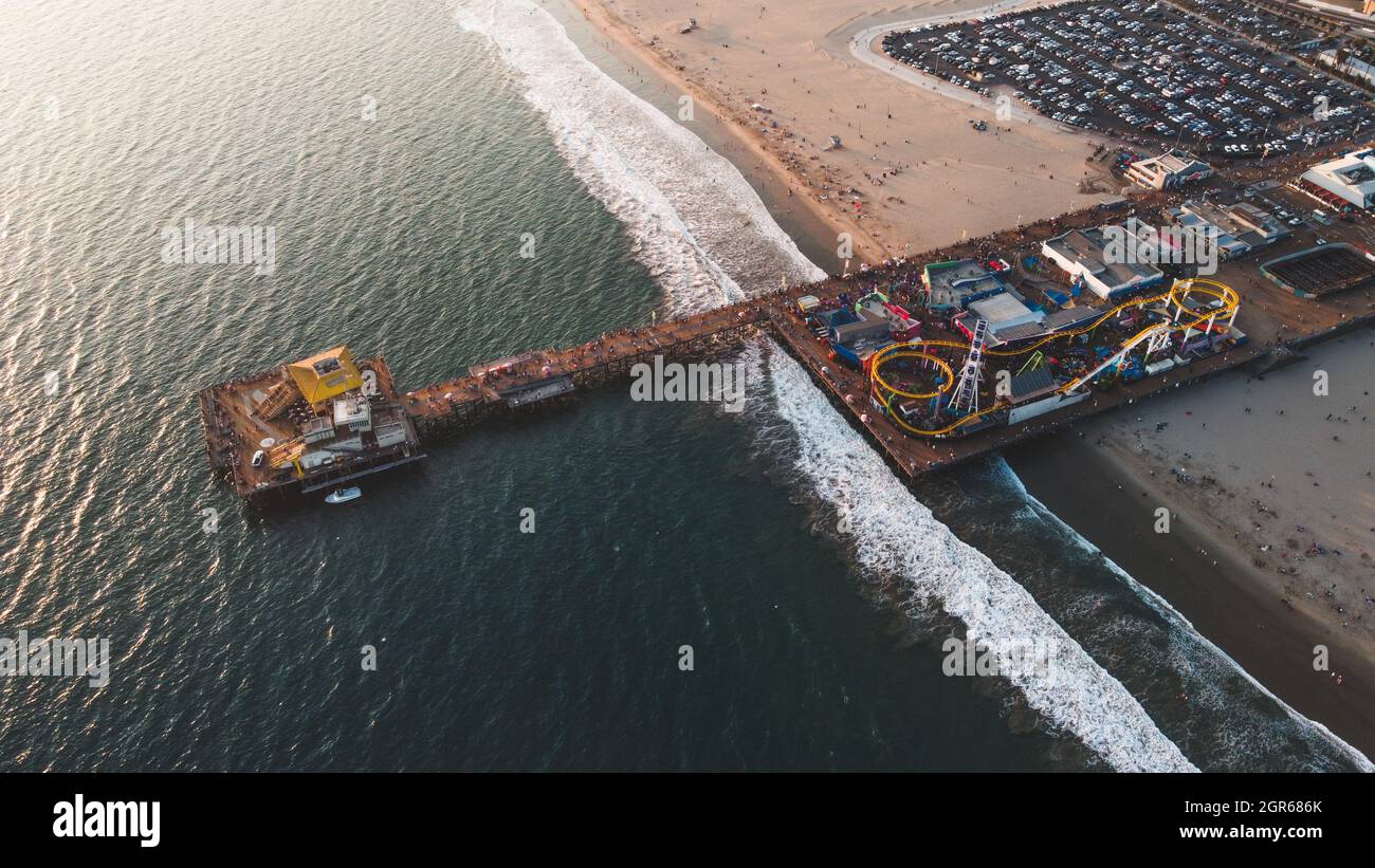Aerial shot of the Santa Monica Pier surrounded by the sea on a sunny ...