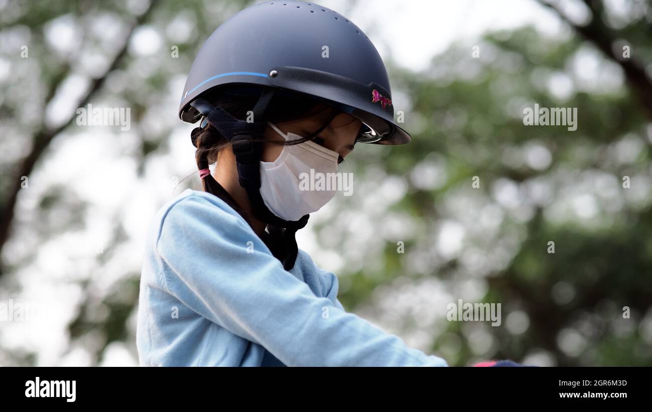 Asian School Kid Riding Or Practicing Horse At Horse Ranch. Stock Photo