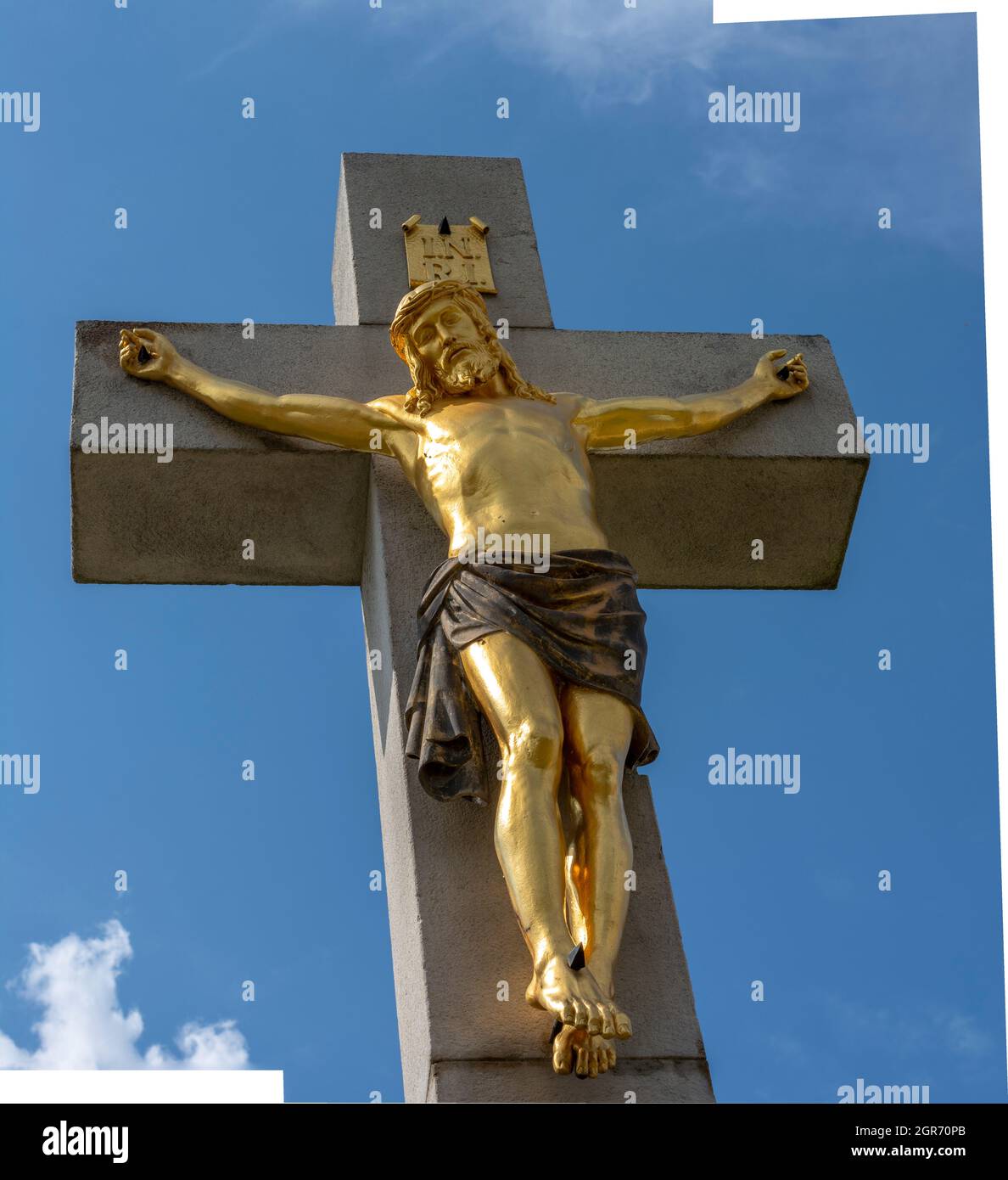 Golden crucified Jesus Christ on the cross. Close up. Detail. Nitra Calvary. Slovakia. Stock Photo