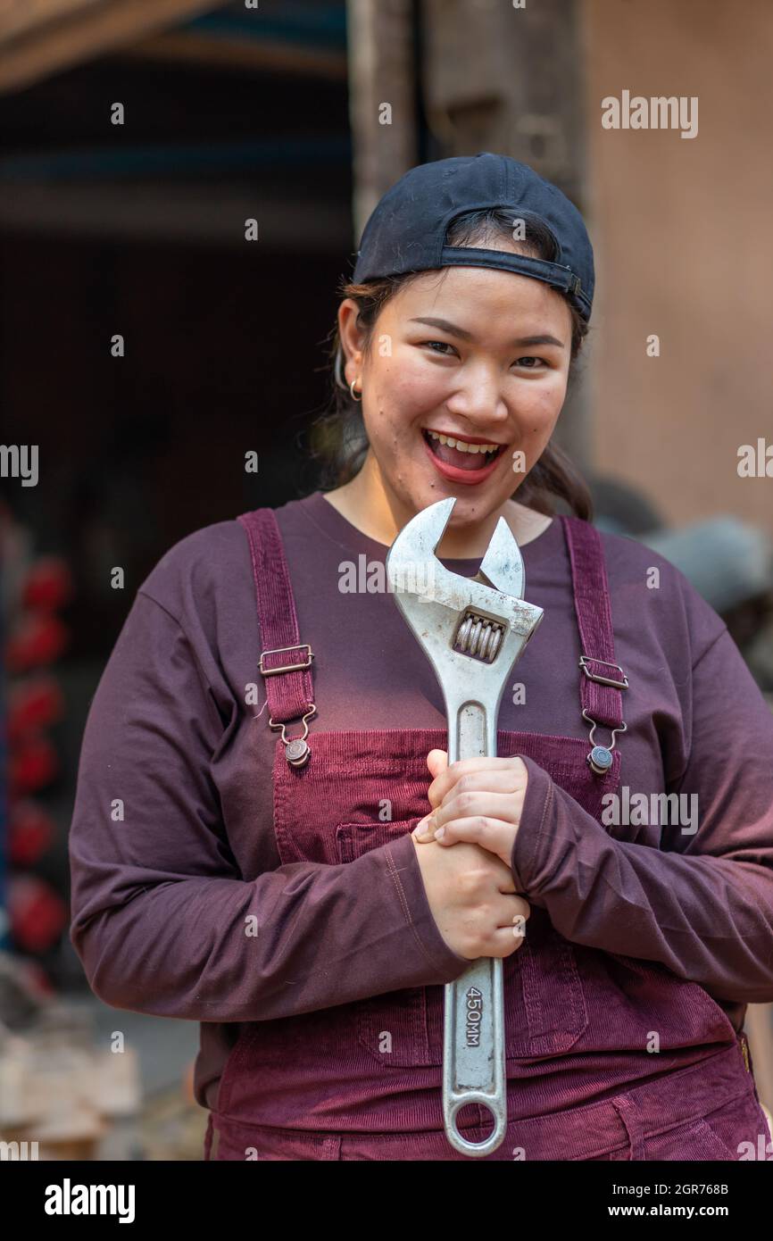 Female Repairman Repair Shop Maintenance Worker With Repair Tools In