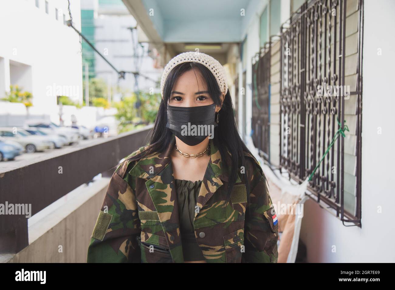 Portrait Asian Woman In Green Army Jacket In Front Of An Old Home  Apartment, Life During Coronavirus Stock Photo - Alamy